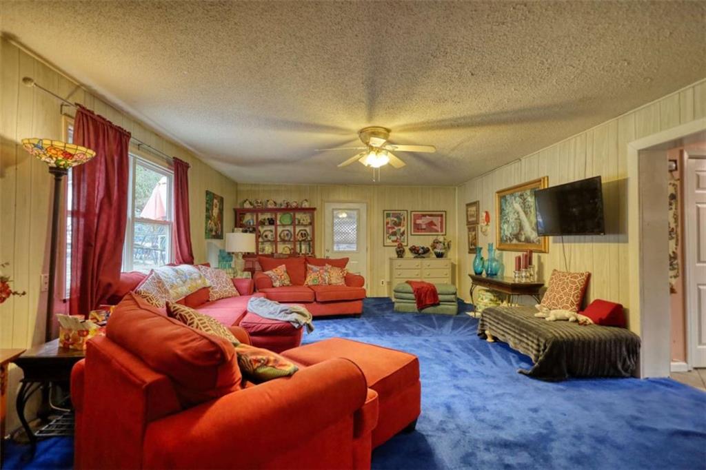 279 Spring Street Winder, GA 30680 - Photo 36 of 43 a living room with furniture and a flat screen tv