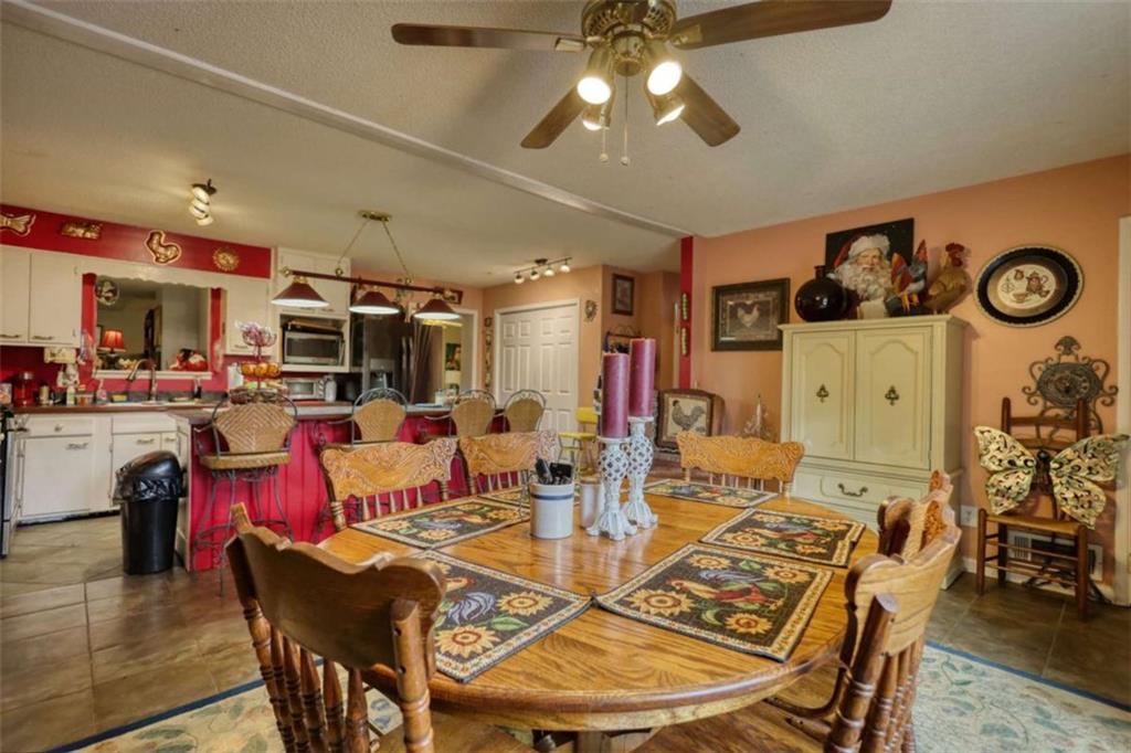 279 Spring Street Winder, GA 30680 - Photo 10 of 43 a view of a dining room with furniture and wooden floor