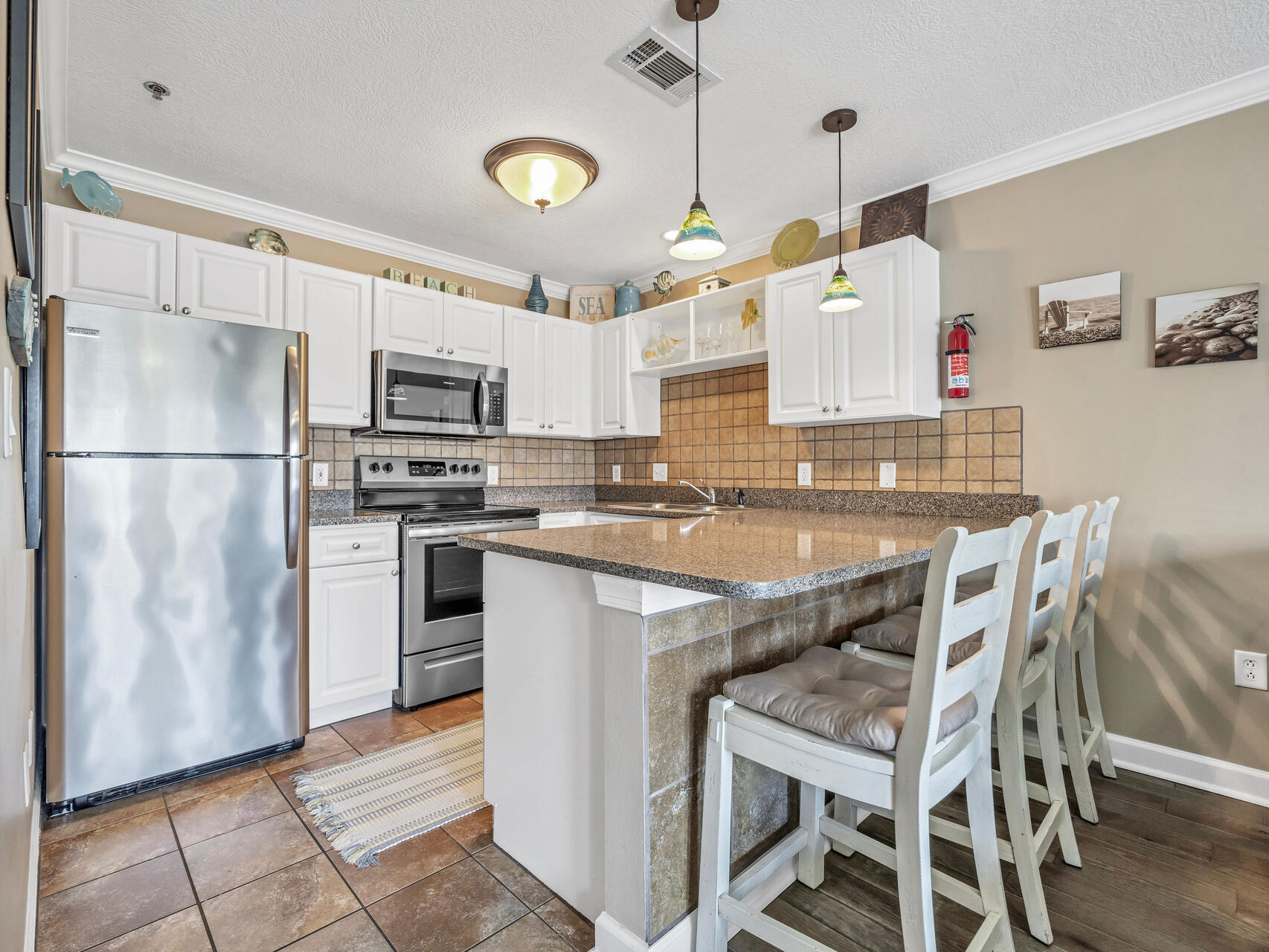 144 Spires Lane, Unit 209 Santa Rosa Beach, FL 32459 - Photo 3 of 27 a kitchen with kitchen island a counter and a refrigerator