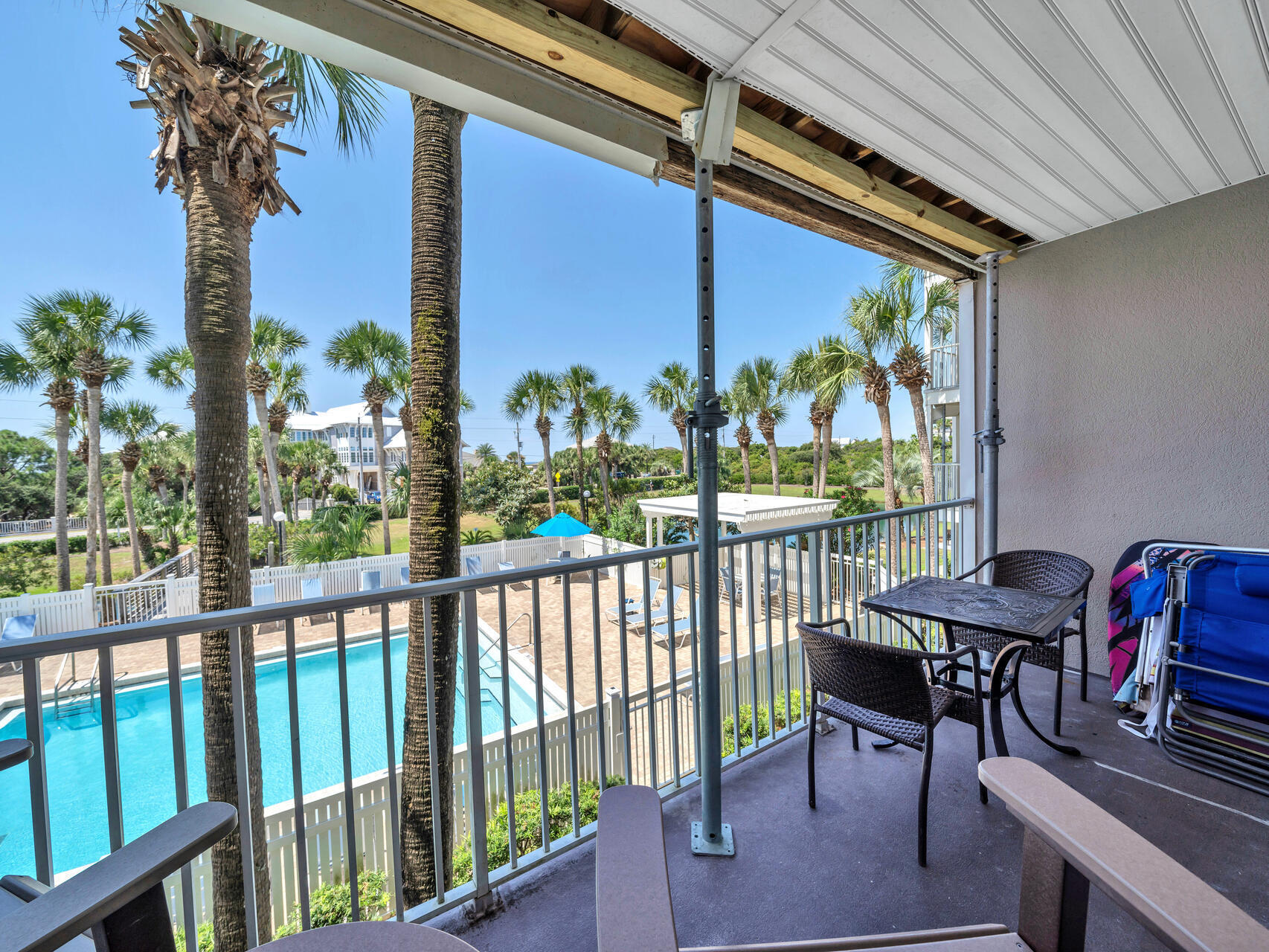 144 Spires Lane, Unit 209 Santa Rosa Beach, FL 32459 - Photo 8 of 27 a view of a balcony with chairs and a potted plant
