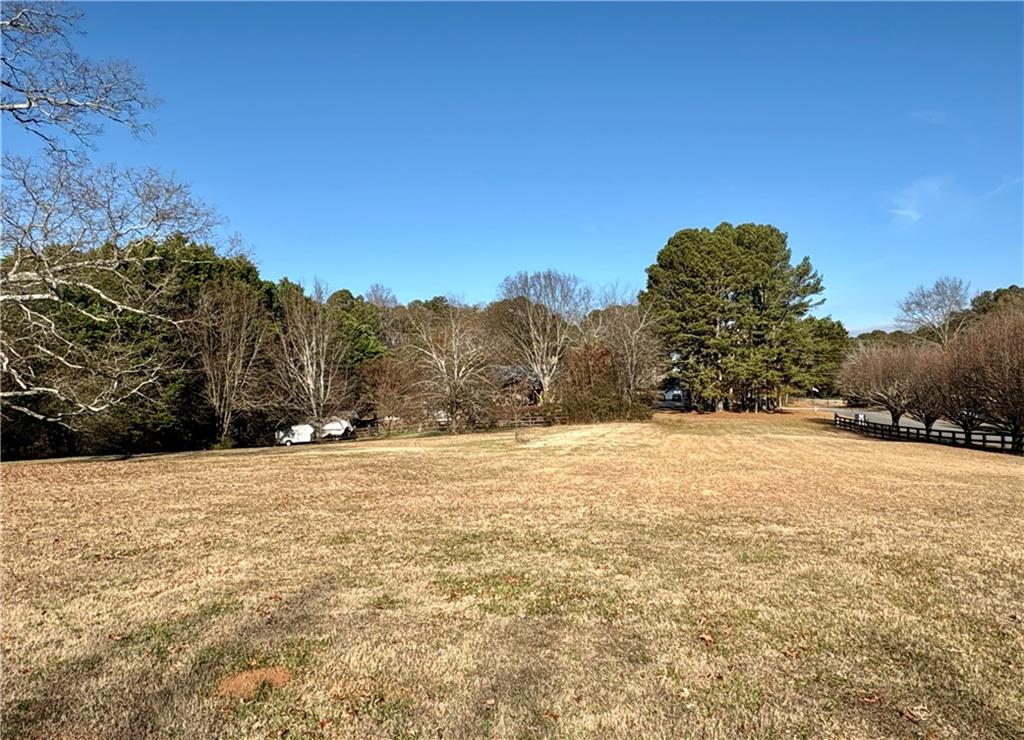 5463 Heardsville Road Cumming, GA 30028 - Photo 12 of 16 a view of large trees with wooden fence