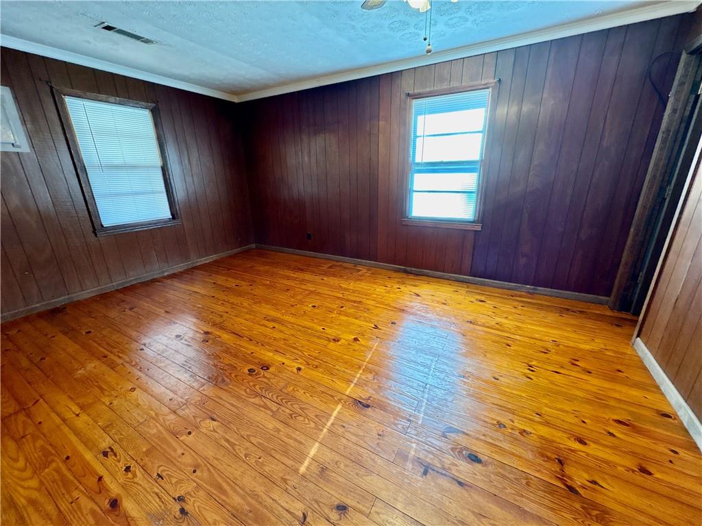 5463 Heardsville Road Cumming, GA 30028 - Photo 5 of 16 a view of empty room with wooden floor and fan