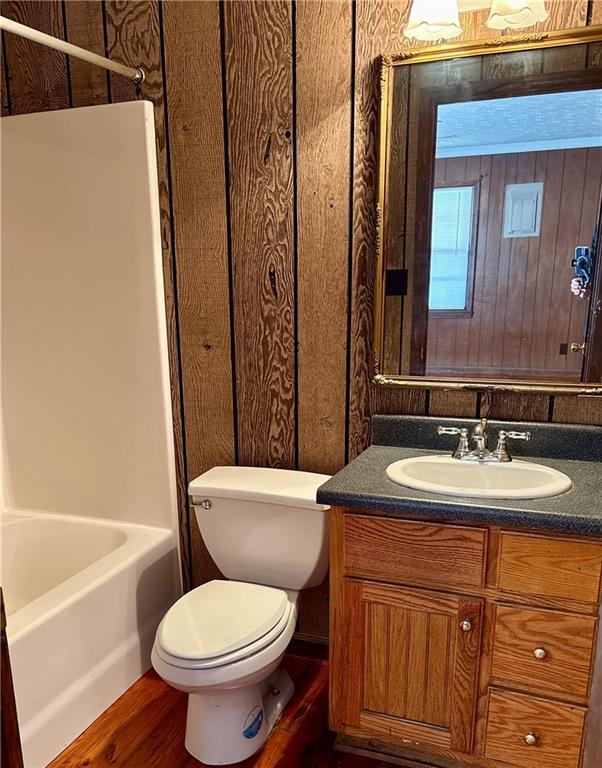 5463 Heardsville Road Cumming, GA 30028 - Photo 6 of 16 a bathroom with a sink a toilet and shower