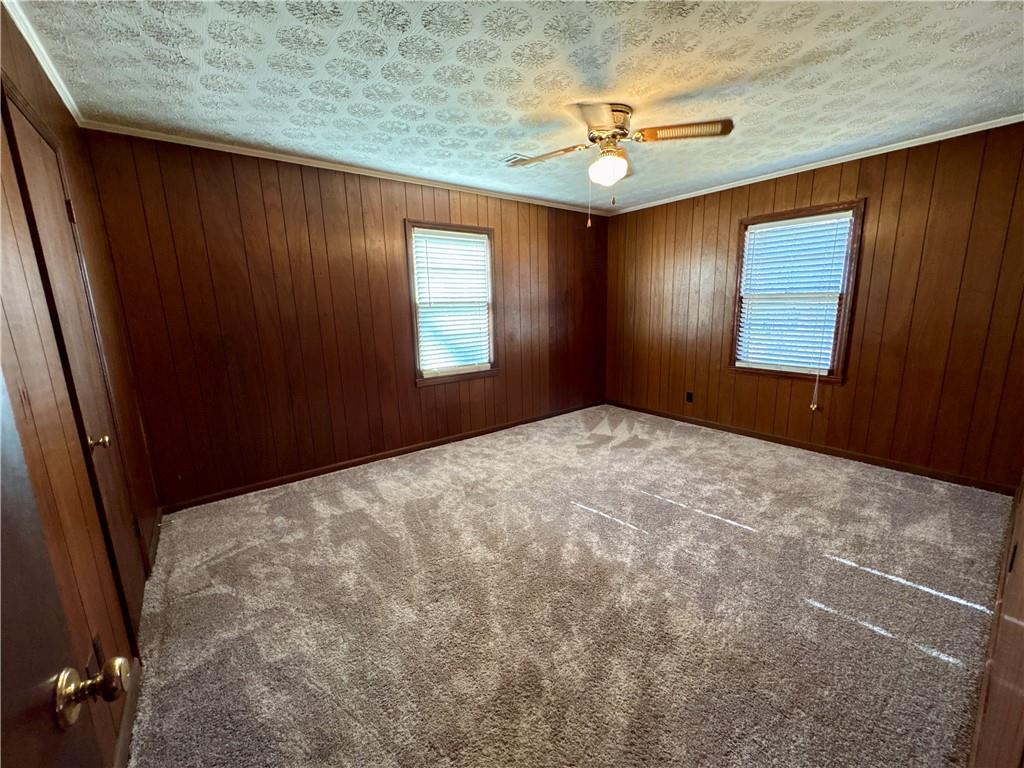 5463 Heardsville Road Cumming, GA 30028 - Photo 10 of 16 an empty room with windows and fan