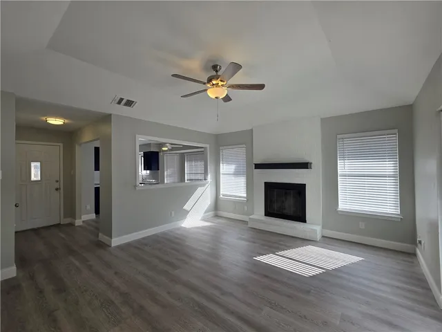 a view of a room window and wooden floor