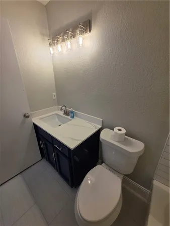 a bathroom with a toilet a sink and a mirror
