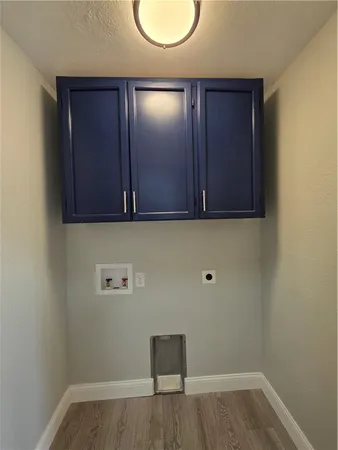a view of a room with wooden floor and a ceiling fan
