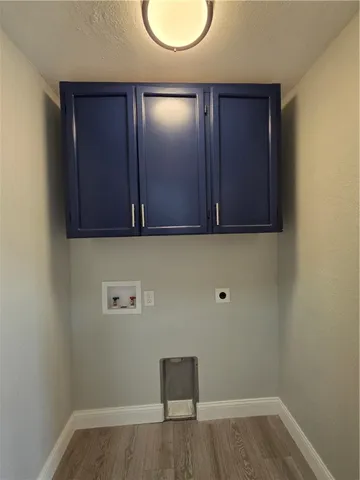 a view of a room with wooden floor and a ceiling fan