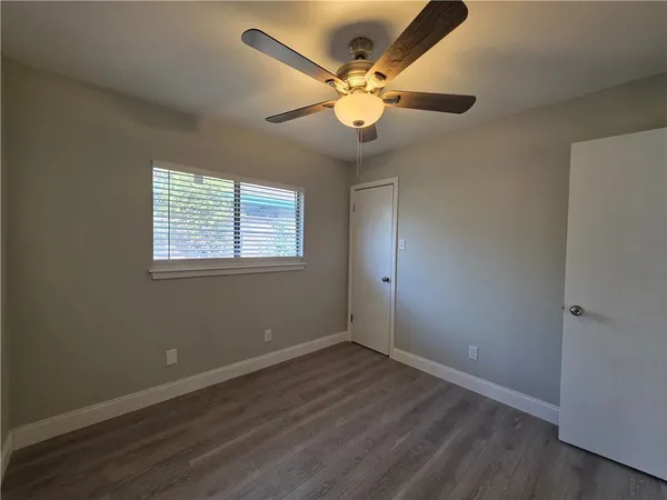 wooden floor in an empty room with a window