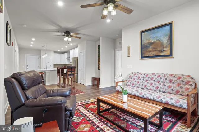 a living room with furniture and a chandelier
