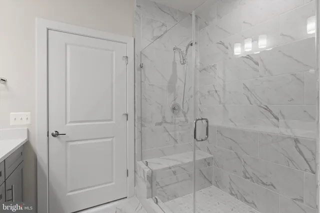 a bathroom with a glass shower door