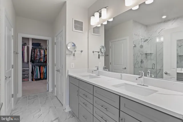 a spacious bathroom with a double vanity sink shower and a mirror