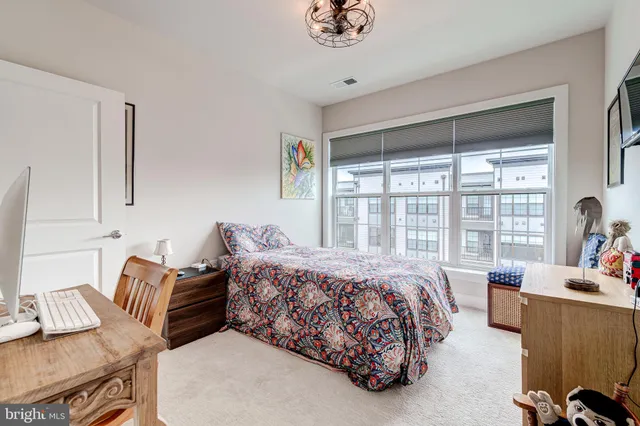 a bedroom with furniture and a large window