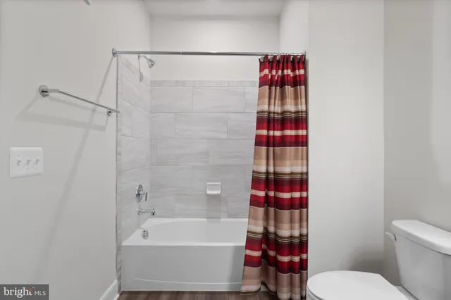 a bathroom with a shower and a toilet
