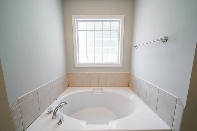 a white bath tub sitting in a bathroom