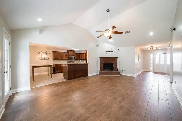 a view of a kitchen with a stove cabinets and wooden floor
