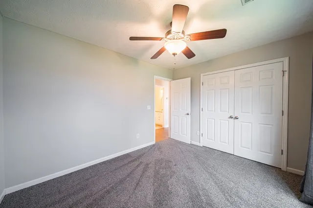 an empty room with closet and wooden floor