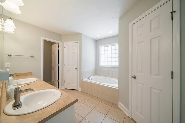 a bathroom with a sink a toilet and tub