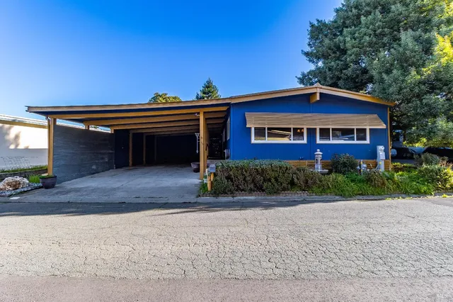 a front view of a house with a yard and a garage