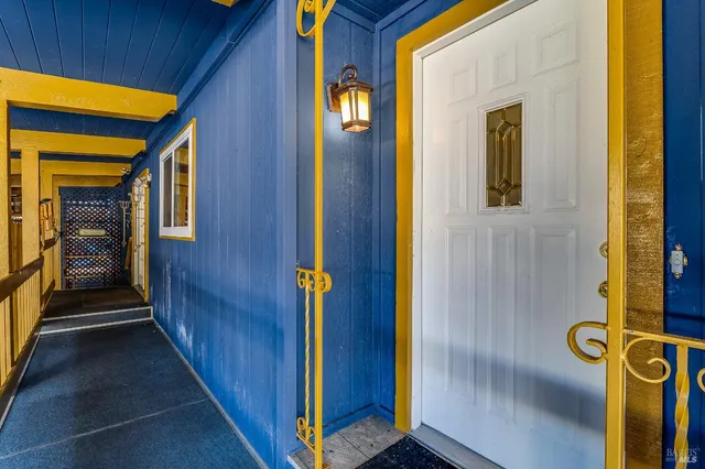 a view of empty room with wooden floor and fireplace