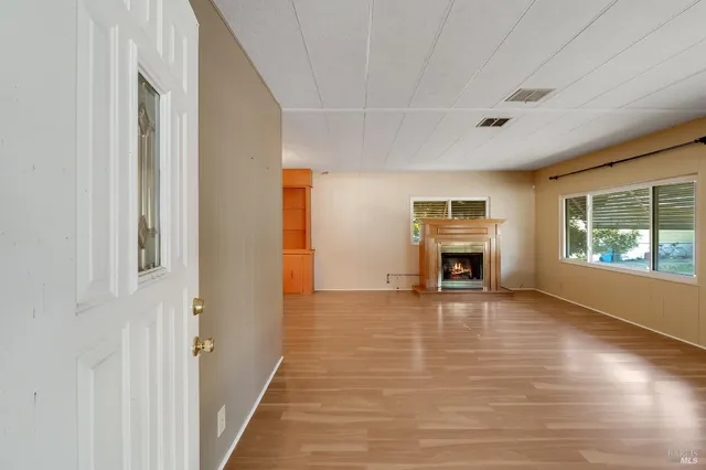 a view of a big room with wooden floor staircase and a living room