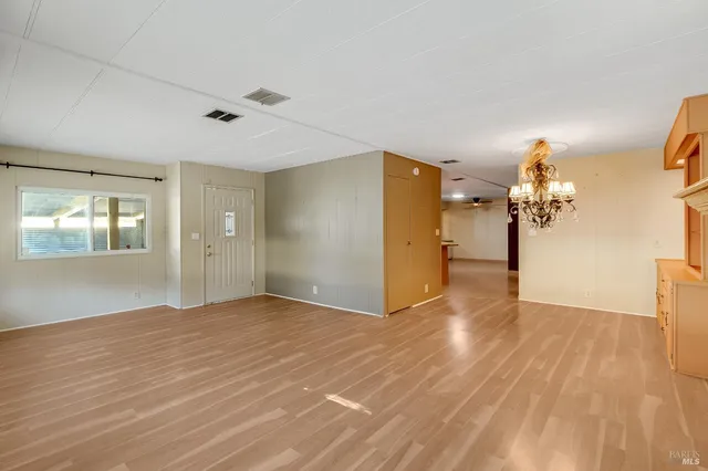 a view of a kitchen with a sink and a refrigerator