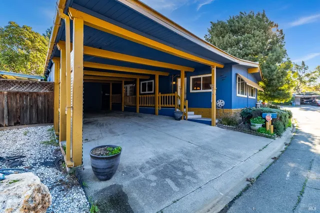 a front view of a house with porch and sitting area
