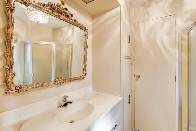 a bathroom with a shower sink and mirror