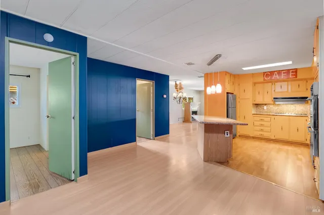 a view of a kitchen with a refrigerator and a sink