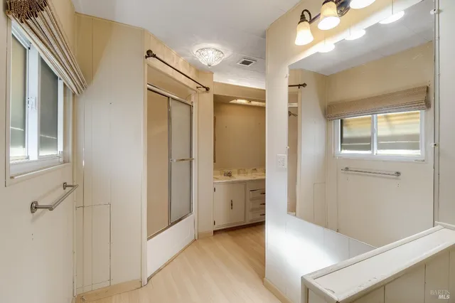 a view of a house with backyard and a tree