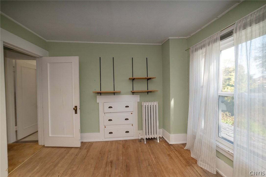 167 Beverly Road Syracuse, NY 13207 - Photo 30 of 50 Classic hardwood floors and a built-in dresser characterize this versatile room.