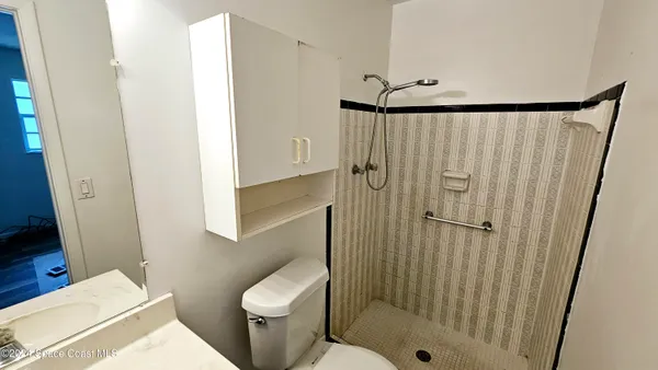 an empty room with wooden floor and window