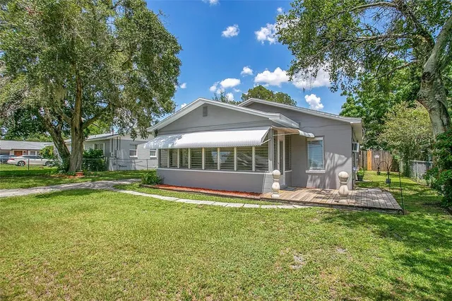 a view of a house with a yard porch and sitting area