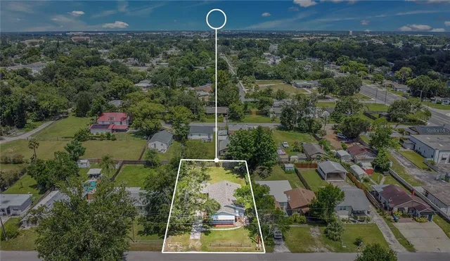 an aerial view of a house with a yard