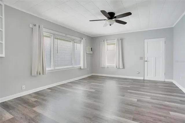 wooden floor in an empty room with a window