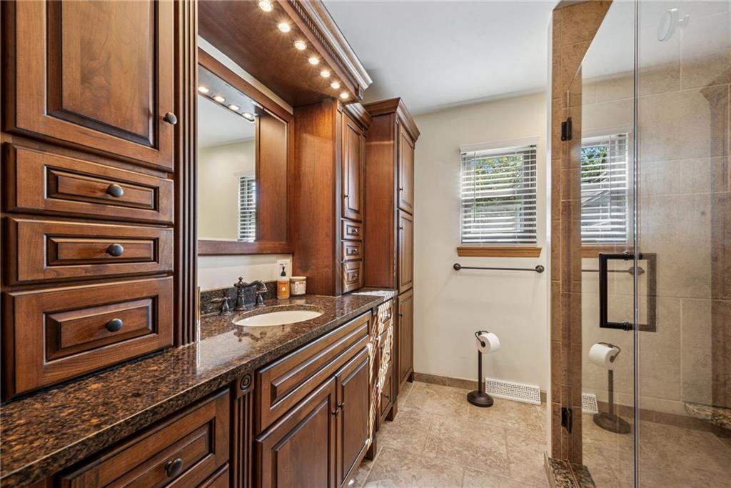 1508 Cemetery Street Monessen, PA 15062 - Photo 21 of 41 a bathroom with a granite countertop sink a mirror and a bathtub