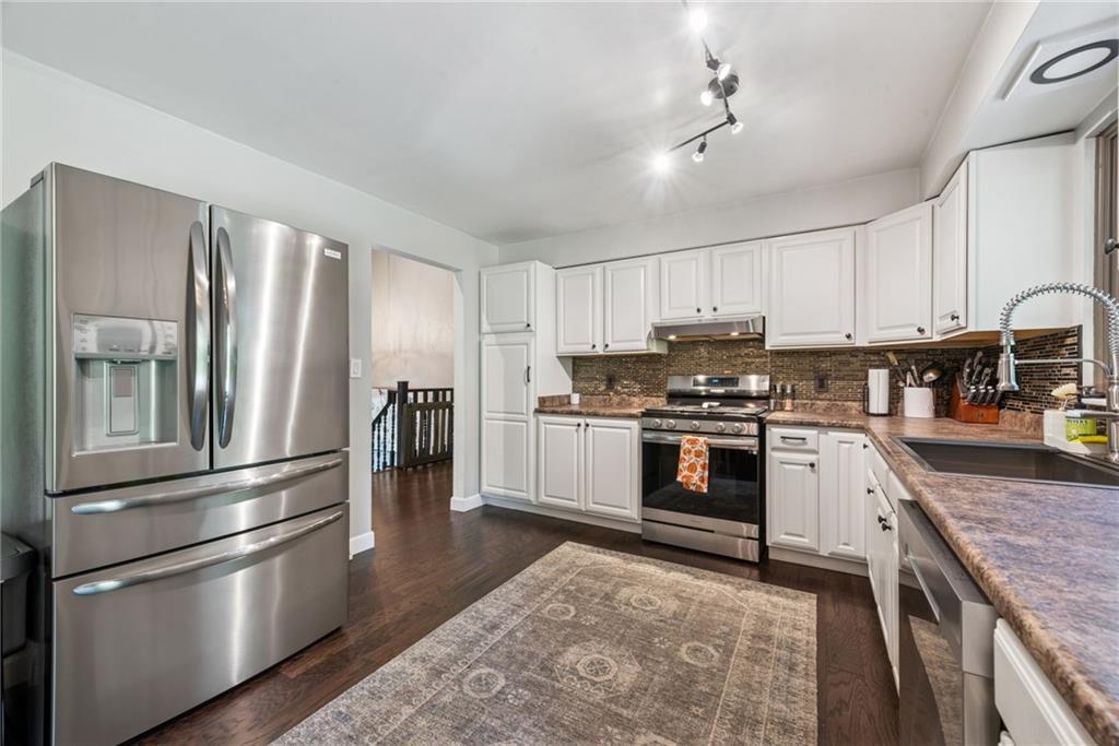 1508 Cemetery Street Monessen, PA 15062 - Photo 9 of 41 a kitchen with granite countertop stainless steel appliances and wooden cabinets