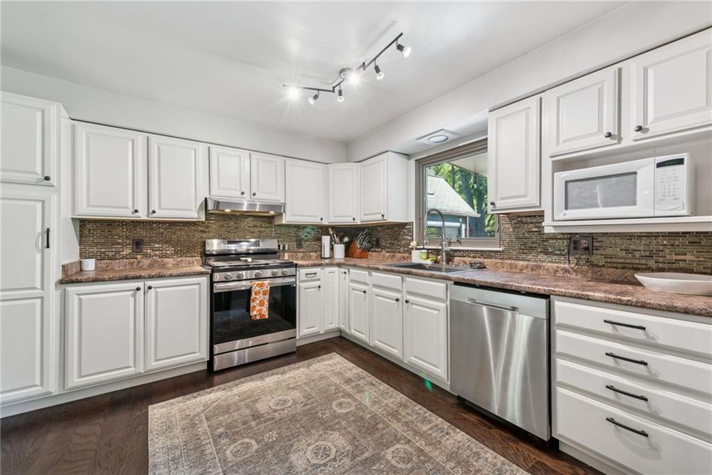 1508 Cemetery Street Monessen, PA 15062 - Photo 10 of 41 a kitchen with granite countertop white cabinets and white appliances