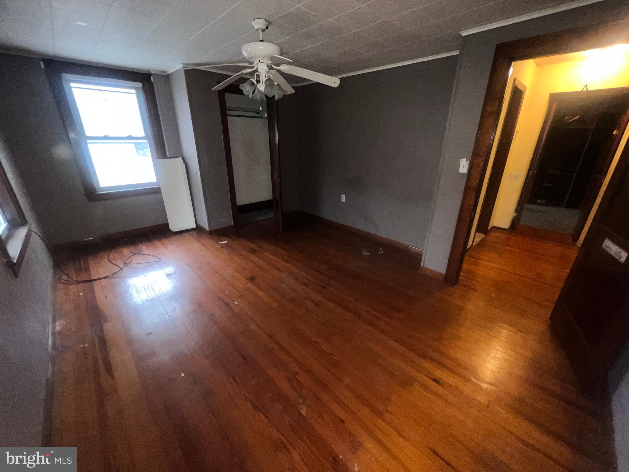 15515 Mt Savage Road Northwest Mount Savage, MD 21545 - Photo 19 of 39 an empty room with wooden floor and windows