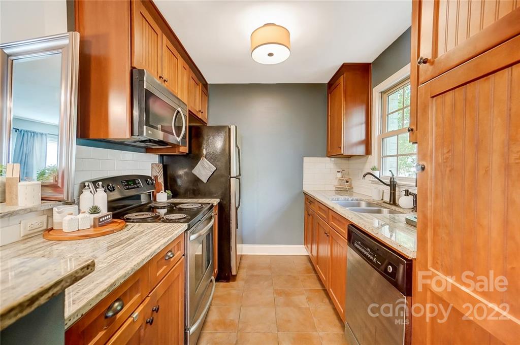 4919 Park Road, Unit C Charlotte, NC 28209 - Photo 11 of 41 a kitchen with stainless steel appliances granite countertop a stove a sink and a refrigerator
