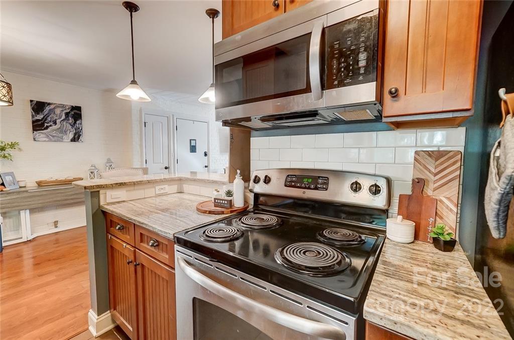 4919 Park Road, Unit C Charlotte, NC 28209 - Photo 15 of 41 a kitchen with a stove and a microwave