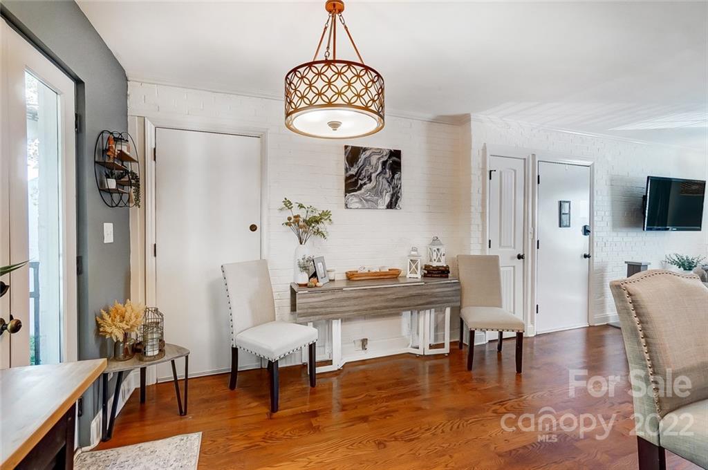 4919 Park Road, Unit C Charlotte, NC 28209 - Photo 16 of 41 a view of a livingroom and dining room with furniture wooden floor a chandelier