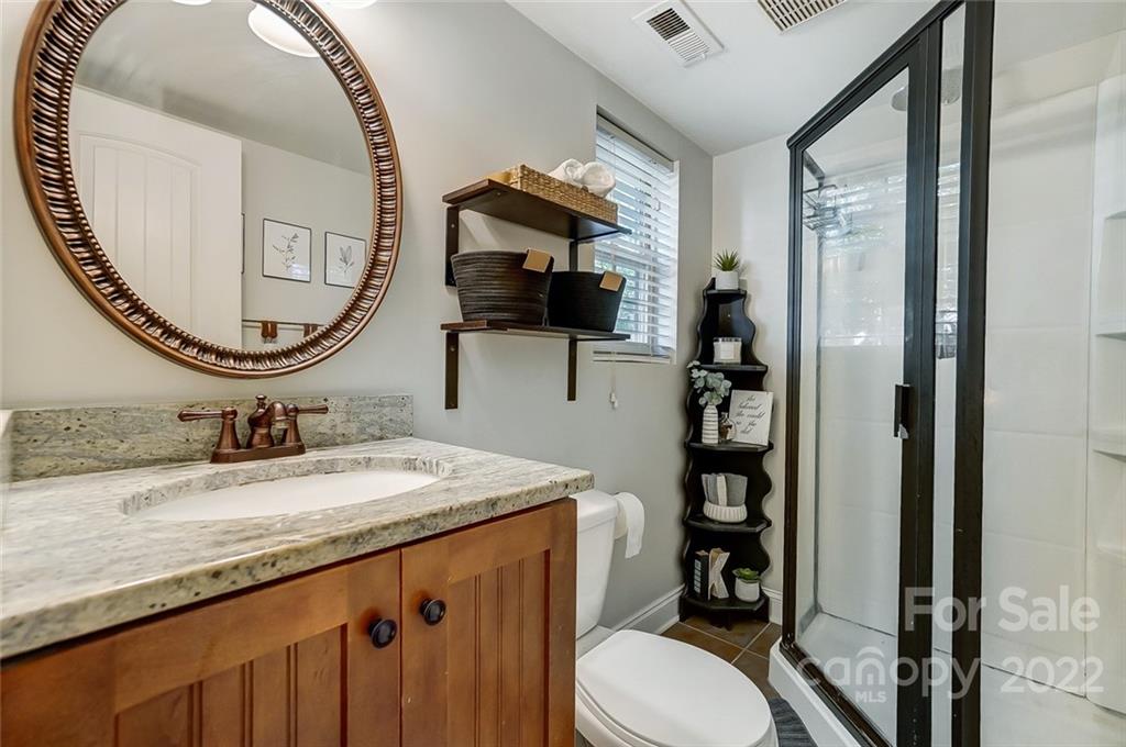 4919 Park Road, Unit C Charlotte, NC 28209 - Photo 26 of 41 a bathroom with a granite countertop double vanity sink and a mirror