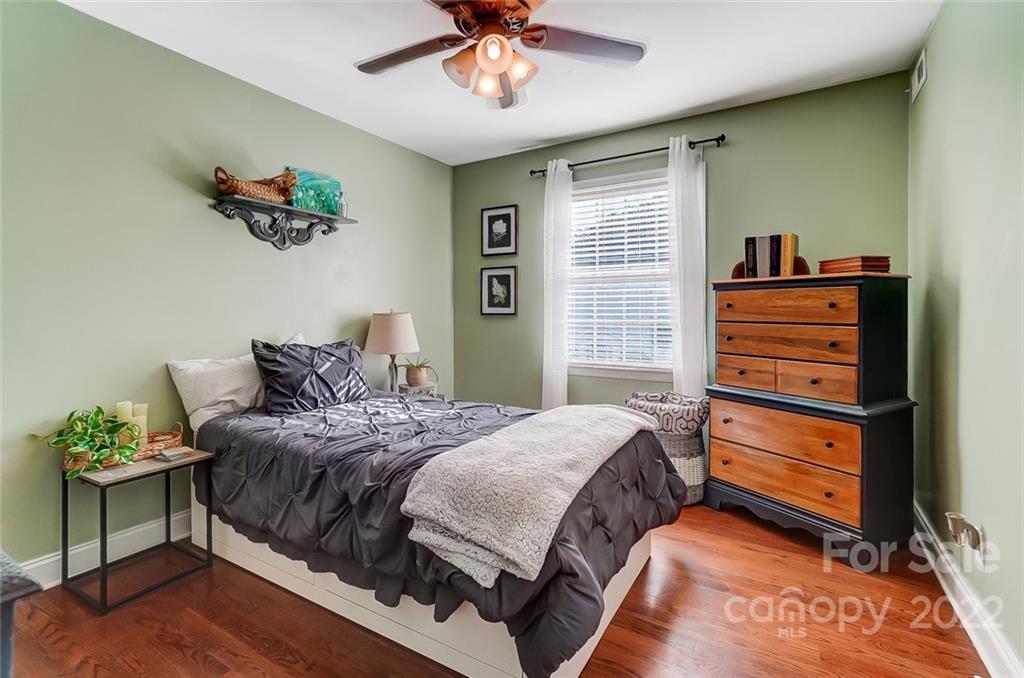 4919 Park Road, Unit C Charlotte, NC 28209 - Photo 31 of 41 a bedroom with a bed and a chandelier