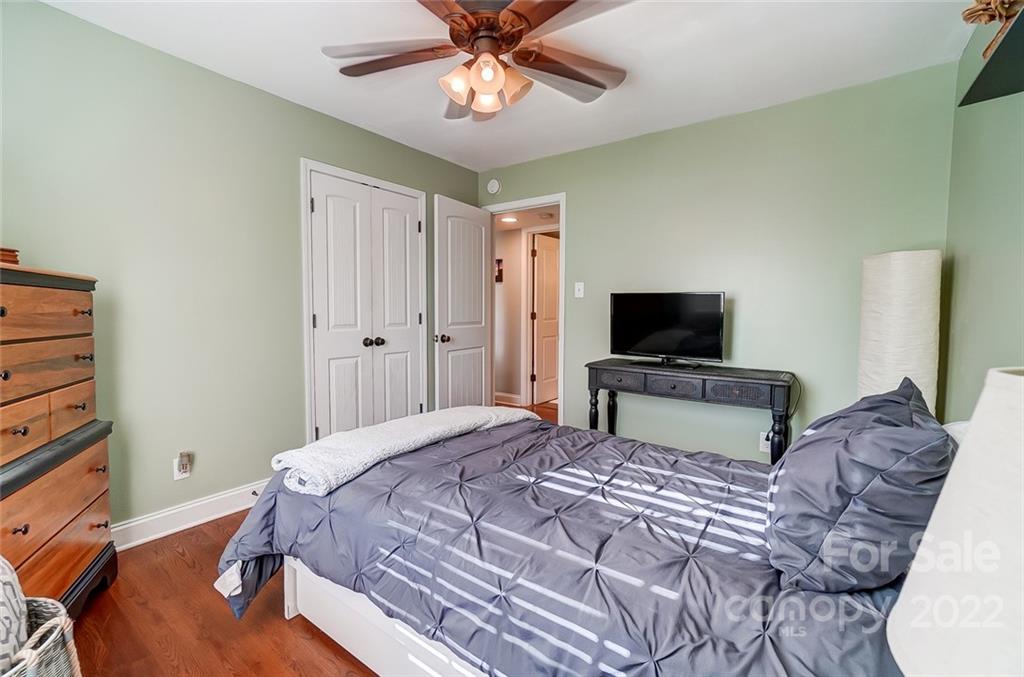 4919 Park Road, Unit C Charlotte, NC 28209 - Photo 34 of 41 a bedroom with a bed and a flat tv screen on the dresser