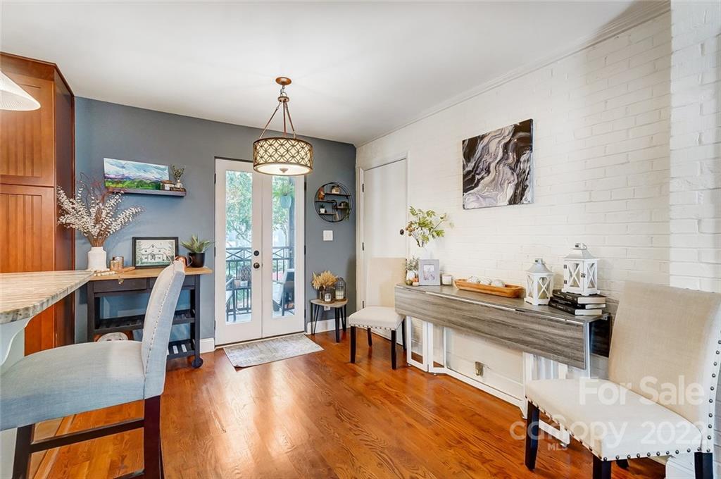 4919 Park Road, Unit C Charlotte, NC 28209 - Photo 8 of 41 a dining room with furniture a chandelier and wooden floor