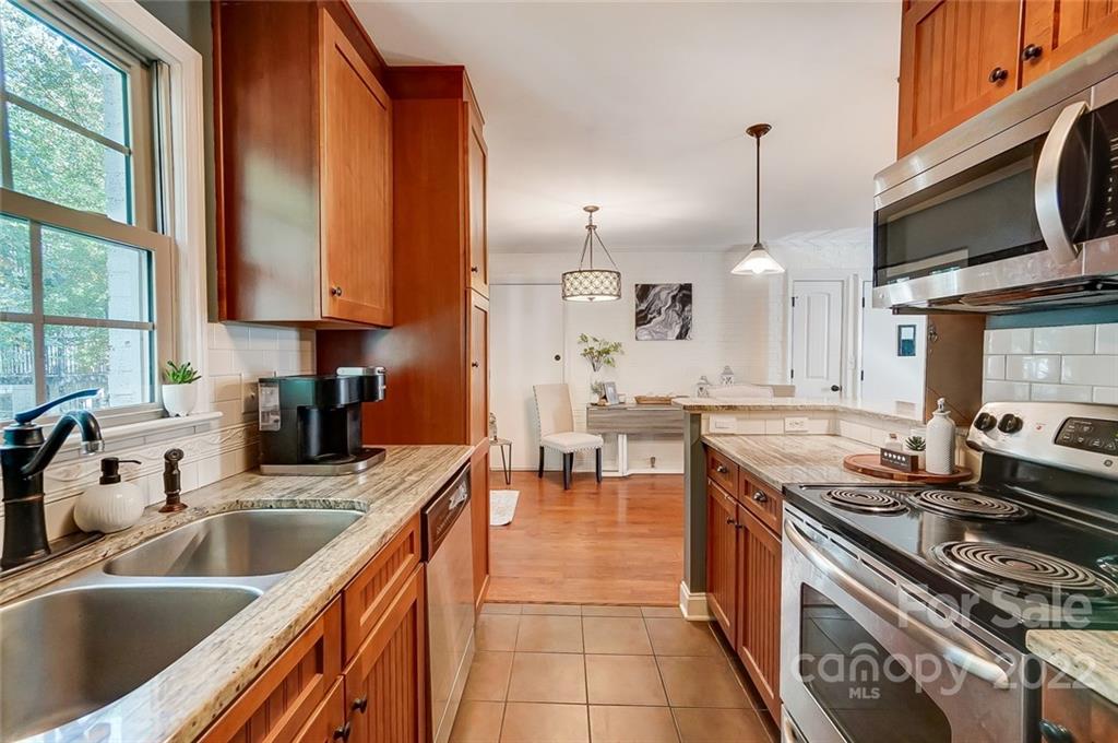 4919 Park Road, Unit C Charlotte, NC 28209 - Photo 10 of 41 a kitchen with stainless steel appliances a sink a stove and a microwave