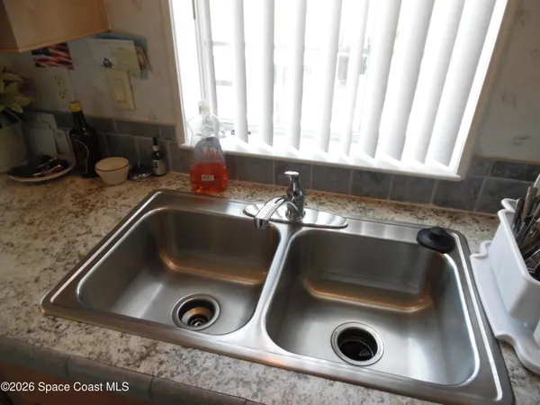 a kitchen with a refrigerator and a sink