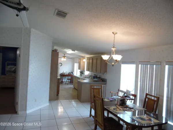 a view of a kitchen with dining area a sink and kitchen view