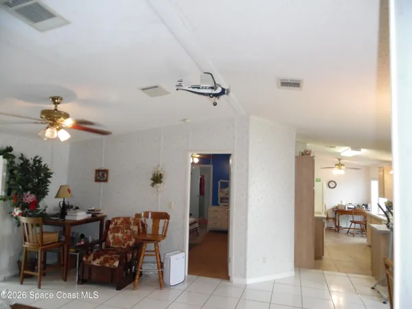 a living room with furniture a chandelier and a window